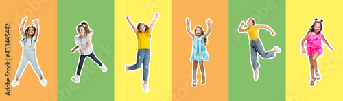 Art collage made of portraits of little and happy kids isolated on multicolored studio background. Human emotions, facial expression concept © master1305