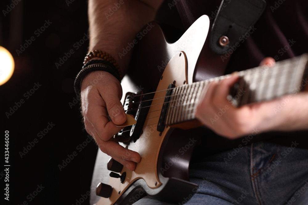 Fototapeta premium Man playing electric guitar on stage, closeup. Rock concert