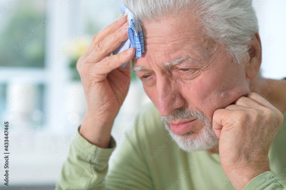 Portrait of sad sick senior man with headache Portrait of sad sick senior man with headache