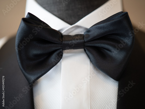 Close up of White tuxedo jacket suit with big black bow and black handkerchief
