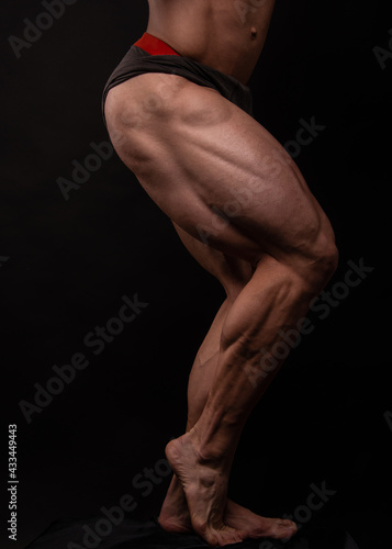 Muscled male legs on isolated background
