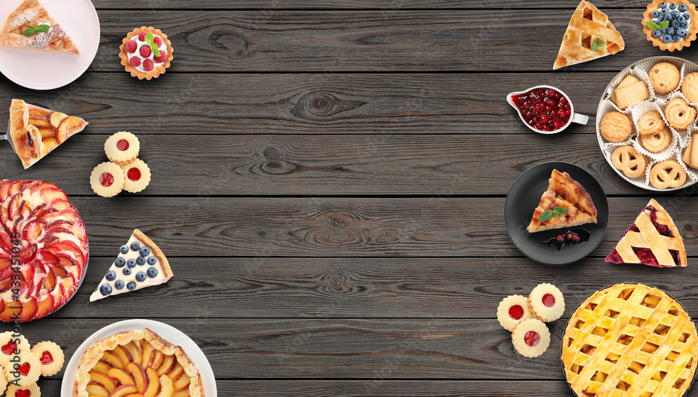 Many different delicious pies on wooden table, flat lay. Space for text Many different delicious pies on wooden table, flat lay. Space for text