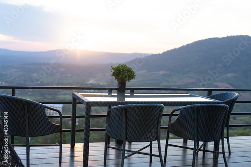 Tables and chairs in the cafe overlooking the mountain scenery. And sunset © Iknew