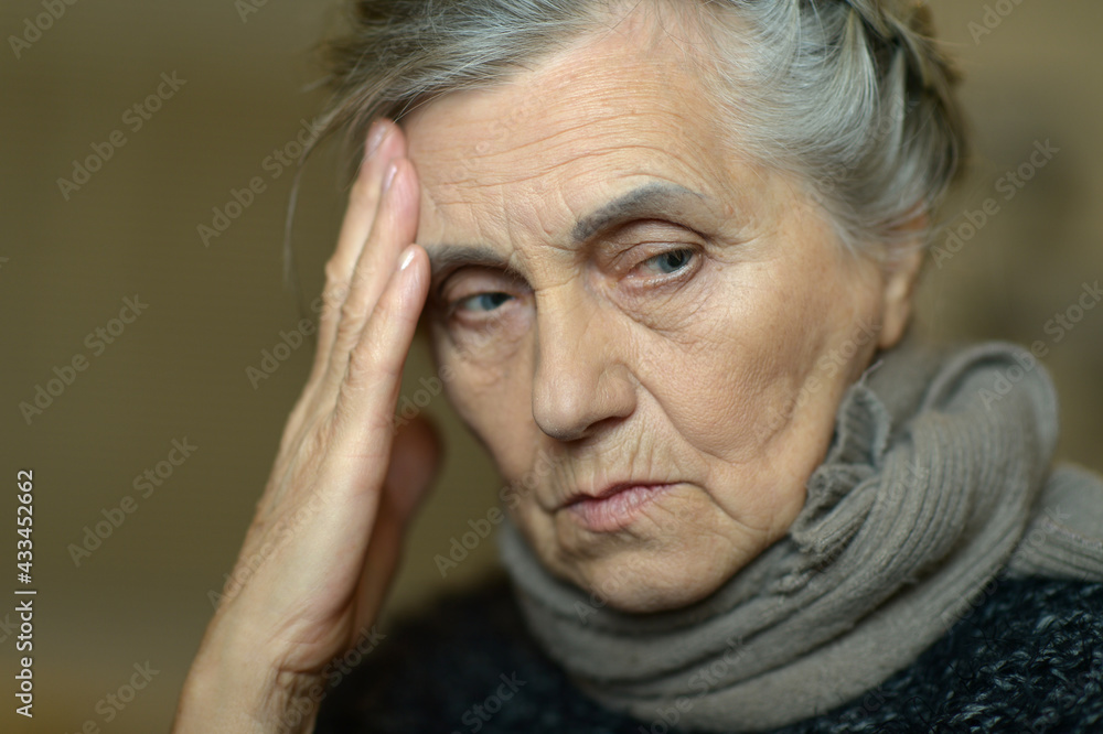 Close up portrait of sad ill senior woman with headache Close up portrait of sad ill senior woman with headache