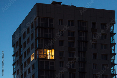 the light burns in one window of the multitude in a multi-storey residential building