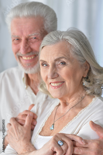  senior couple hugging at home