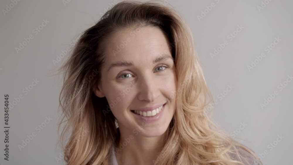 Portrait of a young woman with streaked hair on a wall background Portrait of a young woman with streaked hair on a wall background