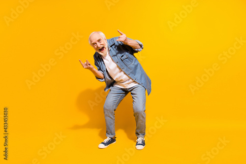 Full length photo of hooray grey beard old man show rock sign wear shirt isolated on orange background