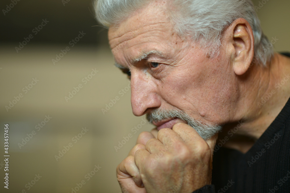 Close up portrait of thoughtful senior man at home Close up portrait of thoughtful senior man at home