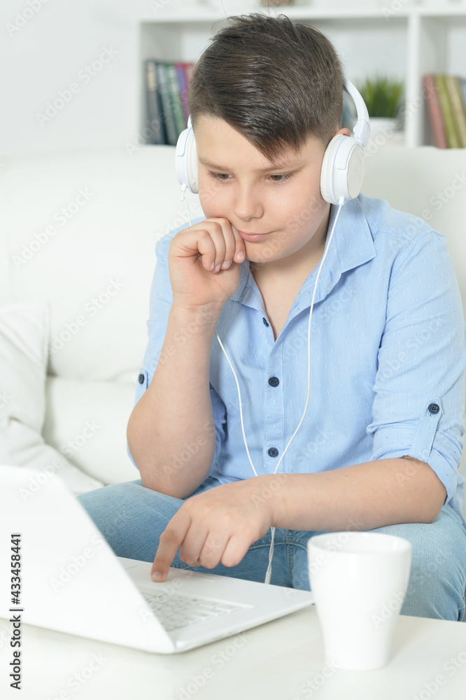 boy with headphones using laptop boy with headphones using laptop