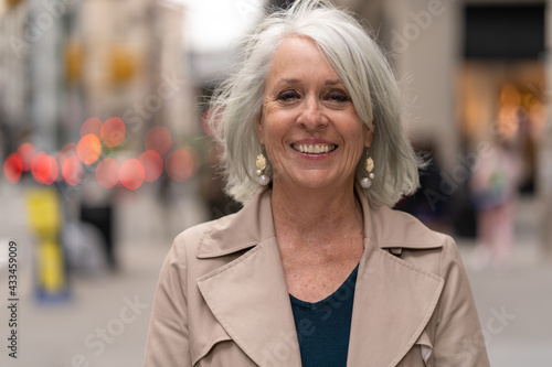 Wallpaper Mural Mature caucasian woman in city smiling happy face portrait Torontodigital.ca