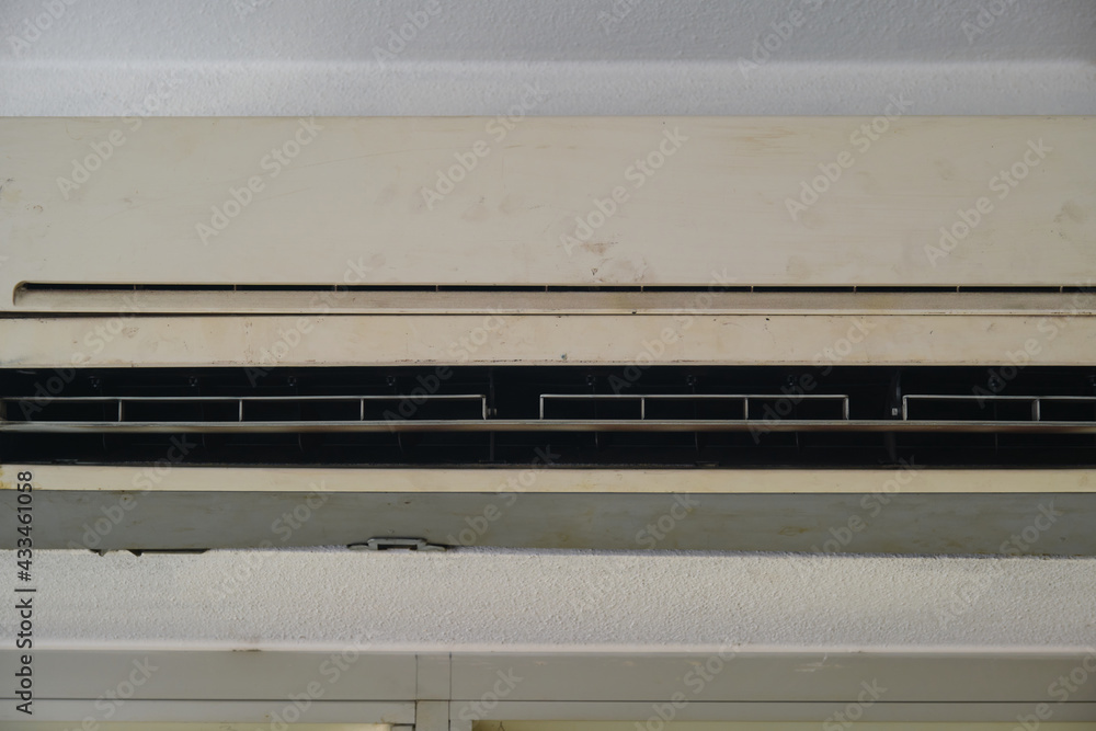Dirty air conditioner. Dirty, uncleaned, neglected white colored air conditioner. Air conditioner whose color changes from white to yellow. Dirty air conditioner. Dirty, uncleaned, neglected white colored air conditioner. Air conditioner whose color changes from white to yellow.