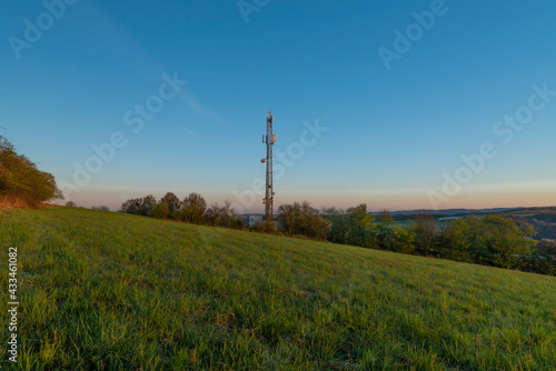 Transmitter near Vizovice town with sunrise of orange sun and fresh color air