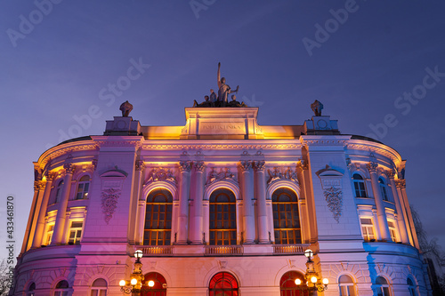 Obraz na płótnie The main building of Warsaw University of Technology at dusk lit by colorful lights. Warsaw, Poland. w salonie