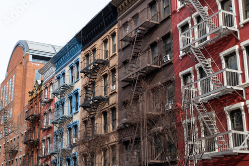 Row of Colorful Old Apartment Buildings in Greenwich Village of New York City with Fire Escapes © James