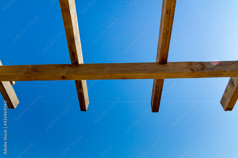 Wooden building materials: cut wooden bars on a construction site Wooden building materials: cut wooden bars on a construction site