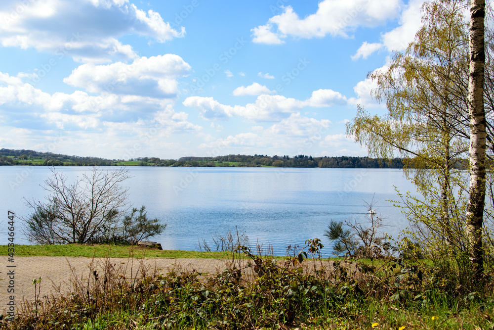 View on a lake with blue sky and clouds
