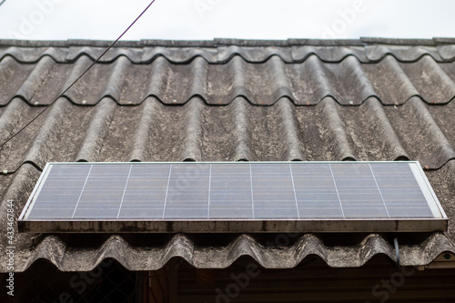 Old solar cell Dirty on the roof of the house, not taking care of the cleaning. photo