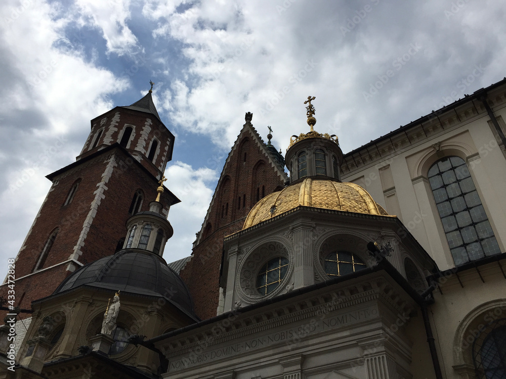 Fototapeta premium Wawel Cathedral on Wawel Hill: Sigismund's Chapel (right, with a gold dome) and Vasa Dynasty chapel and Silver Bell Tower (to the left) in Krakow, Poland