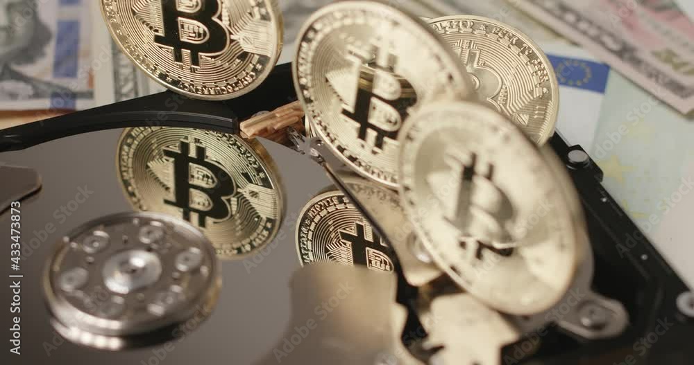 Bitcoin reflecting on HDD platter. Gold coin reflection on silver disk. Crypto currency technology concept Bitcoin reflecting on HDD platter. Gold coin reflection on silver disk. Crypto currency technology concept