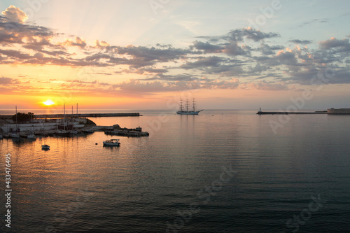 Tourist ship entering the port at sunset © Margo Ladygina