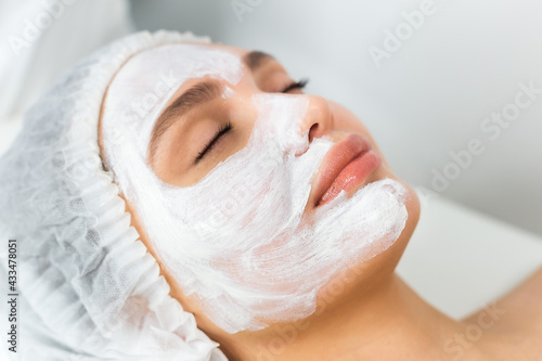 Facial skin care and protection. A young woman at a beauticians appointment. Portrait of a woman with a rejuvenating face mask