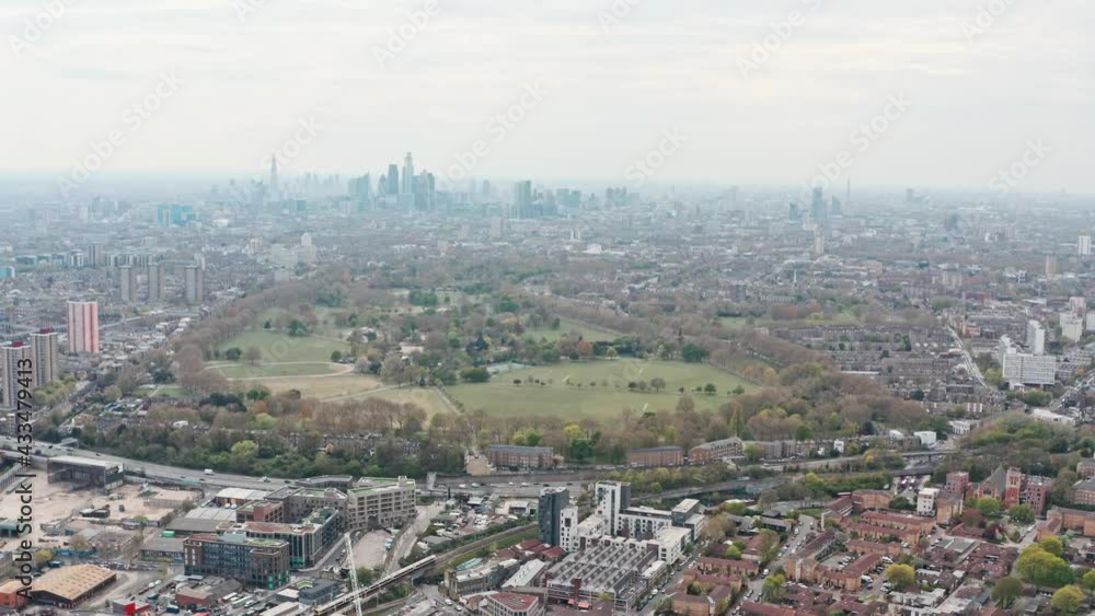 Slider drone shot of Central London skyscrapers from the East over Victoria park Slider drone shot of Central London skyscrapers from the East over Victoria park