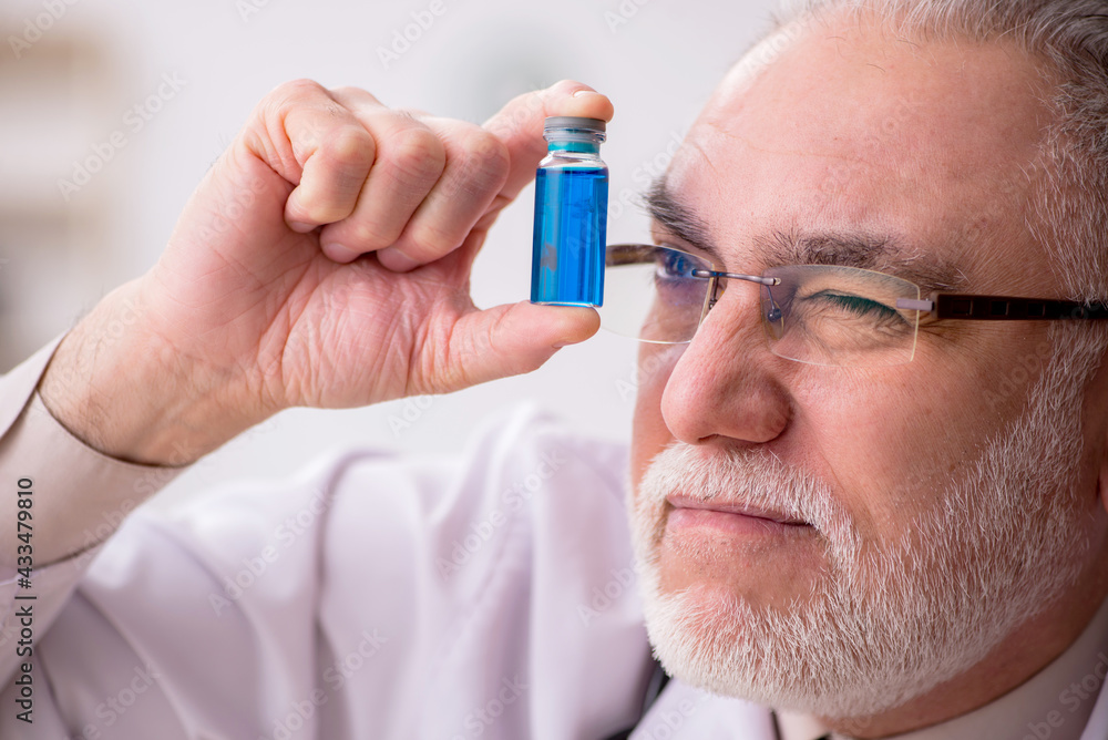Old male doctor in vaccination concept Old male doctor in vaccination concept