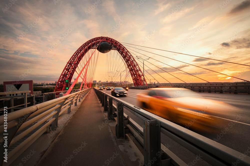 The movement of cars on Zhivoisny bridge in Moscow at sunset