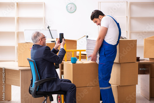 Old businessman and young contractor in relocation concept