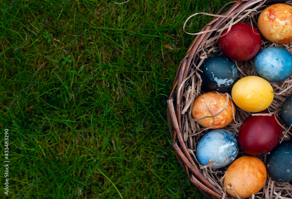 Easter eggs in a basket on the grass Easter eggs in a basket on the grass