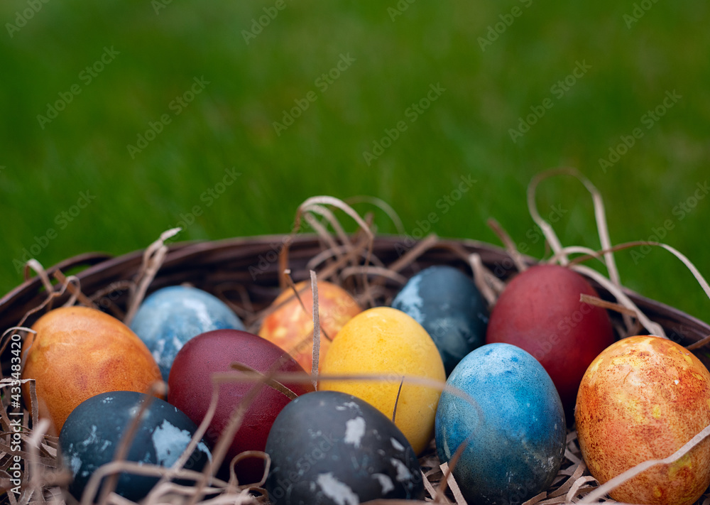 Easter eggs in the basket with green background Easter eggs in the basket with green background