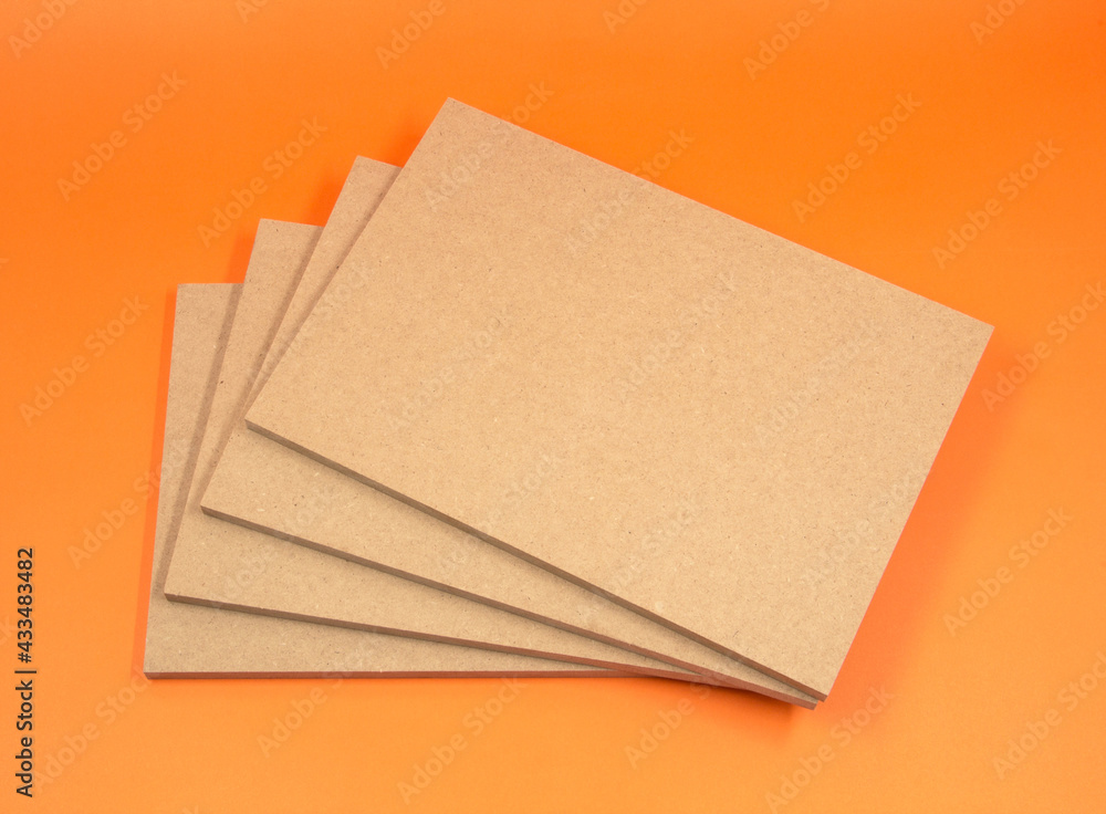 Four boards of raw MDF stacked on top of each other in the shape of a fan. Raw MDF is mostly used in the construction and furniture industries. Four boards of raw MDF stacked on top of each other in the shape of a fan. Raw MDF is mostly used in the construction and furniture industries.