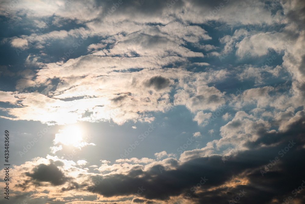 Fototapeta premium The sky after the pouring rain. The rays of the sun through the dark clouds. Photo of the sky.