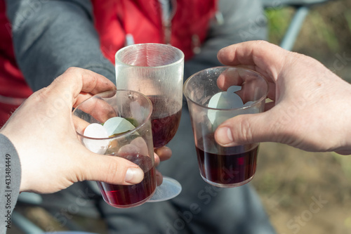 Photography three plastic cups of wine. make a toast on a picnic