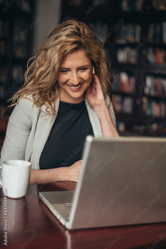 Businesswoman using a laptop for an online meeting while in the office Businesswoman using a laptop for an online meeting while in the office