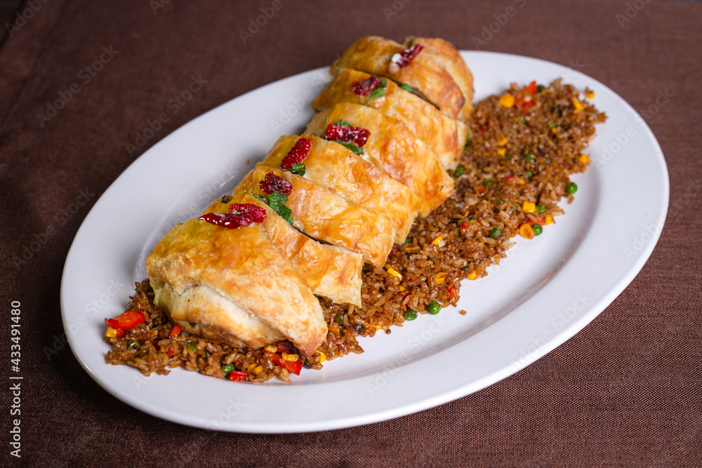 roll with meat baked in the dough. rice for garnish