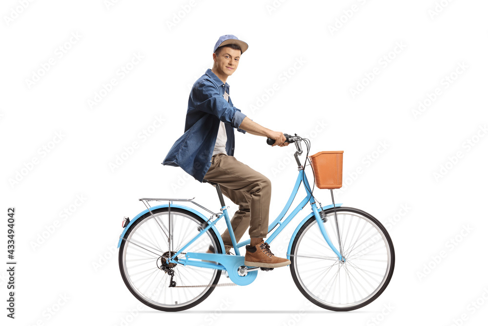 Full length profile shot of a casual young male riding a city bicycle and looking at camera Full length profile shot of a casual young male riding a city bicycle and looking at camera