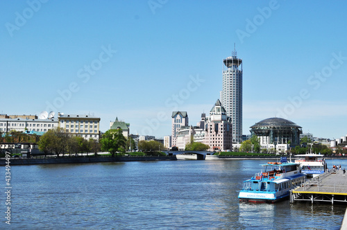 Panoramic view of the Moskva River. Pleasure boats at the pier. View of the high-rise buildings of the city. May 11, 2021, Moscow, Russia.