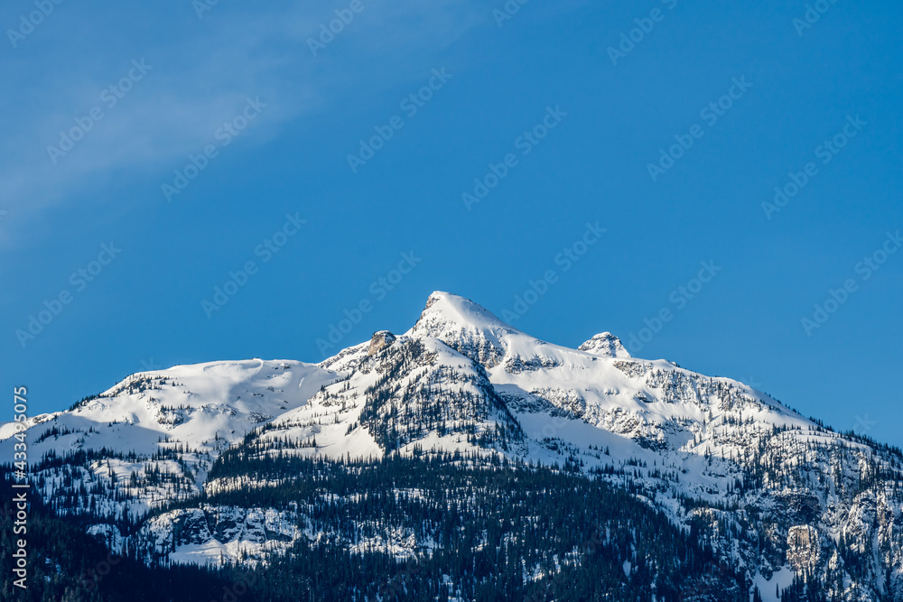 high mountains with snow on top clear blue sky British Columbia Canada