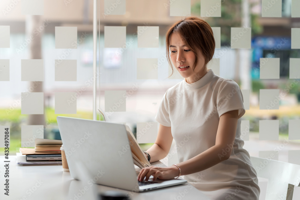 Asian businesswoman working typing job at laptop keyboard at office. Asian businesswoman working typing job at laptop keyboard at office.