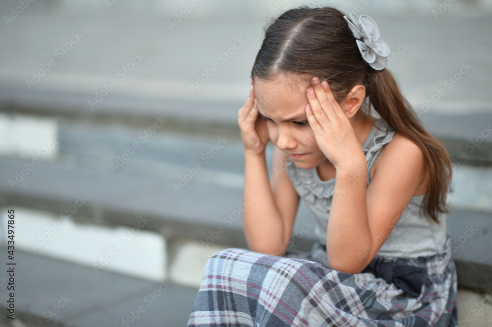 Sad little girl  with headache