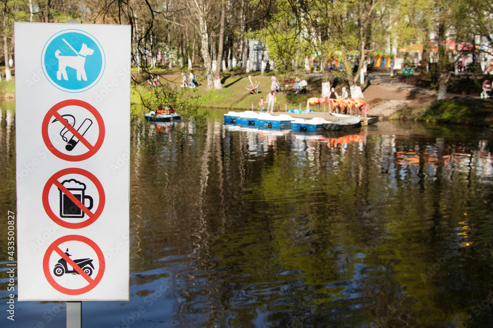 The sign of the prohibition of smoking, drinking alcoholic beverages, motorcycles in the park is allowed to walk with dogs.