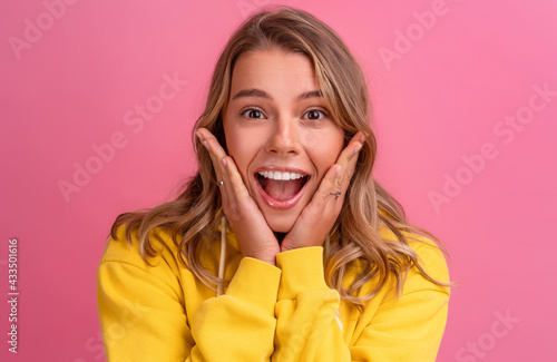 young pretty blonde woman cute face expression posing in yellow hoodie