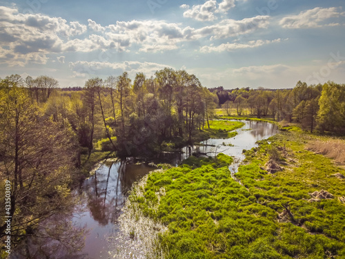 Flight over a small river on a sunny spring day. 