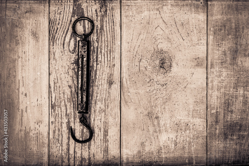 Ancient steelyard on old wooden table covered with blue paint. View from above