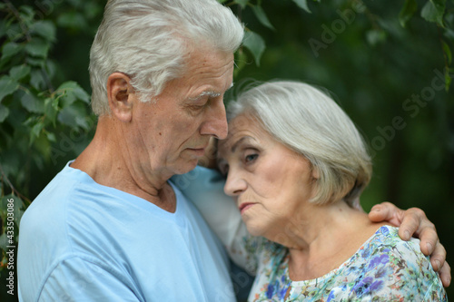 portrait of unhappy senior couple in the park