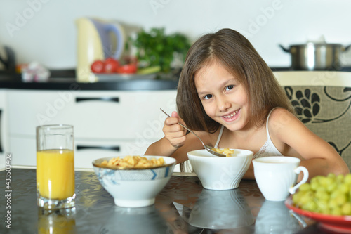 young girl eating   in the kitchen