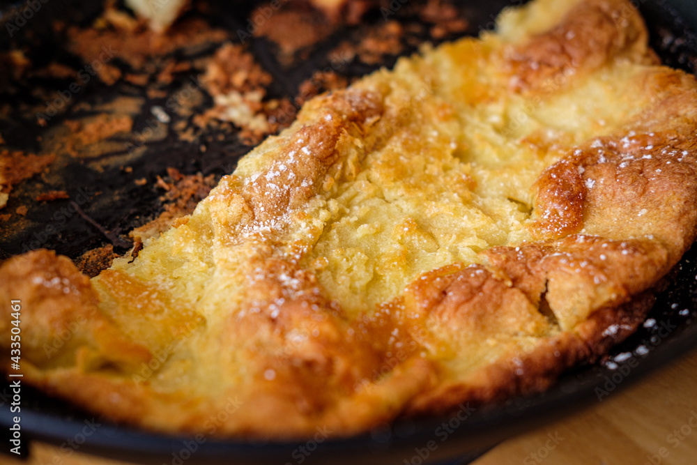 A fresh and hot Dutch Baby in a metal pan