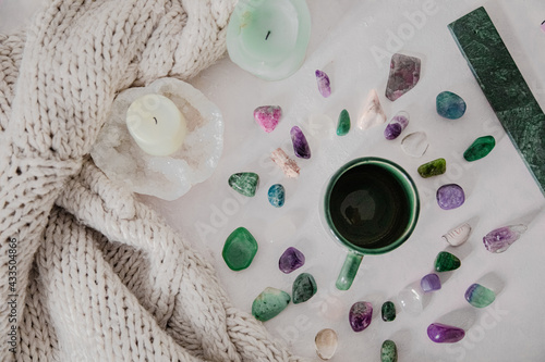 Hygge and spiritual home concept.
gemstones/candle/encent/mug:knitwear